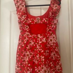 Red dress with floral pattern. Off the shoulders ruffles with cut-out in back